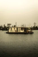 Tranquil houseboat floating on serene - Credits: pexels