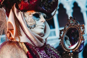 Masked figure in ornate costume - Credits: pexels