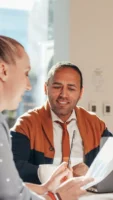 Two professionals discuss ideas in - Credits: pexels