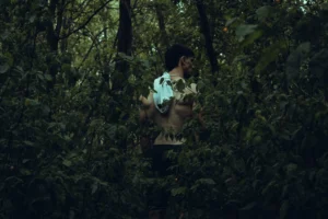 A shirtless man stands mysteriously - Credits: pexels
