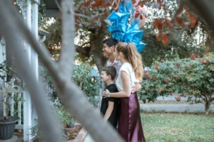 A happy family celebrates outdoors - Credits: pexels