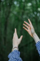 A woman's hands reaching upwards - Credits: pexels
