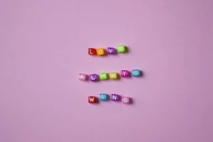 Vibrant colorful letter beads spelling - Credits: pexels