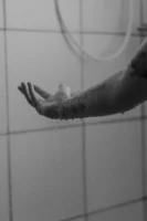 Monochrome photo of a tattooed - Credits: pexels