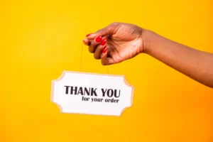 A hand holding a thank - Credits: pexels