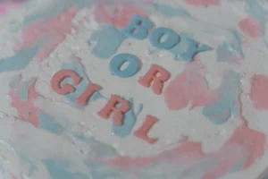 A pastel-colored cake with 'Boy - Credits: pexels