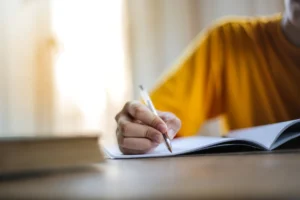 Close-up of a person writing - Credits: pexels
