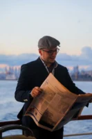 Casually dressed man reading a - Credits: pexels