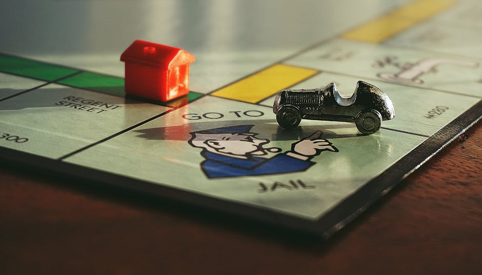 Close-up shot of a Monopoly board game featuring a toy car and a red house on 'Go to Jail'. - Credits: pexels