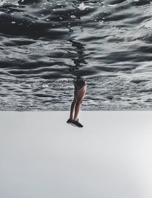 A surreal image of legs appearing to walk on the ocean surface, creating a dreamlike effect. - Credits: pexels.com