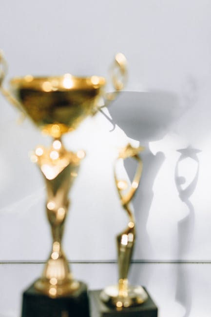 Blurred golden trophies with shadows - Credits: pexels