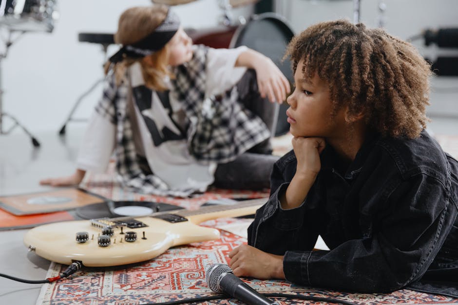Two children engaging with musical instruments in an indoor setting, reflecting on music and creativity. - Credits: pexels